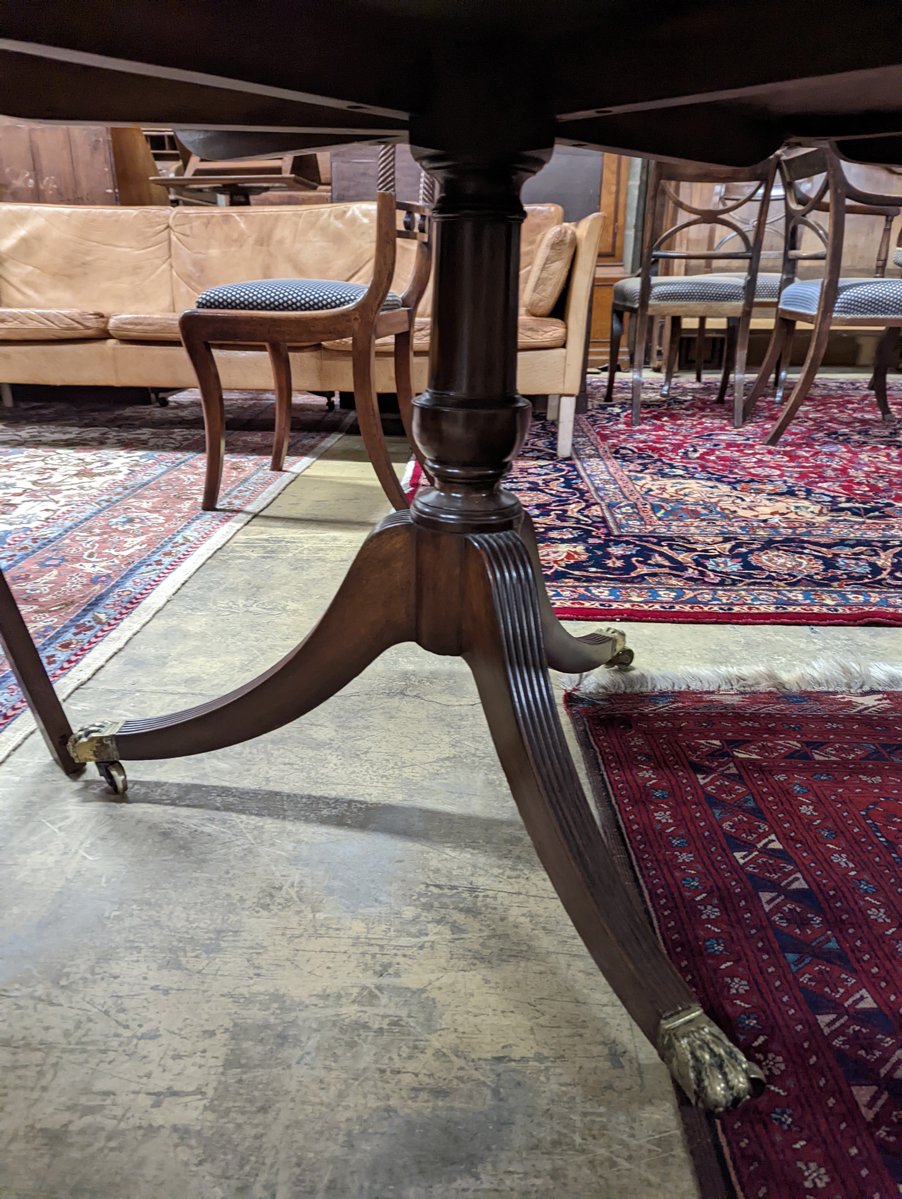 A George III style mahogany twin pillar extending dining table, length 244cm extended, width 106cm, height 72cm